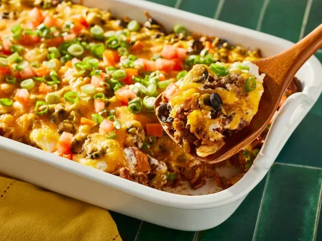 A delicious taco casserole featuring layers of beans and colorful vegetables, baked to perfection and ready to serve ideas with ground beef for dinner