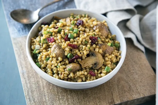 A creamy barley and mushroom risotto garnished with fresh herbs, showcasing a rich, earthy color palette dishes made with hamburger meat