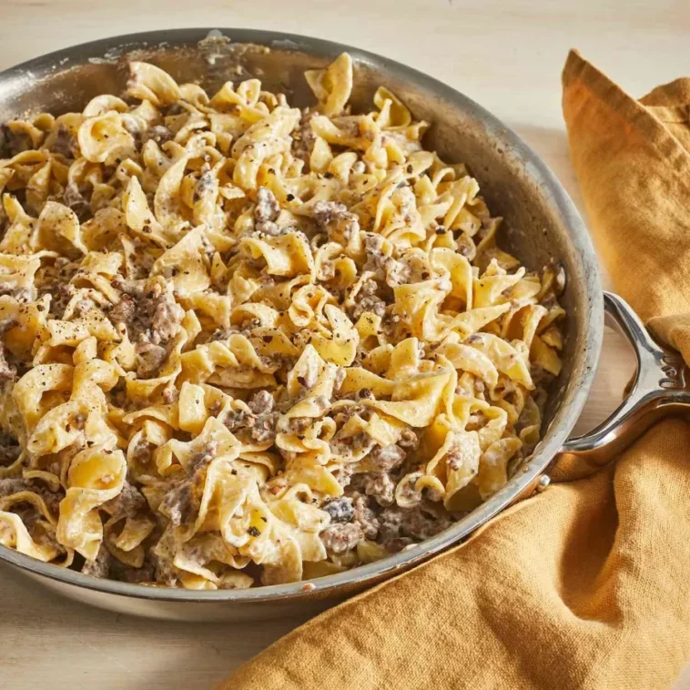 1. A pan of pasta and meat sits on a table, ready to be served, showcasing a delicious meal: dishes made with hamburger