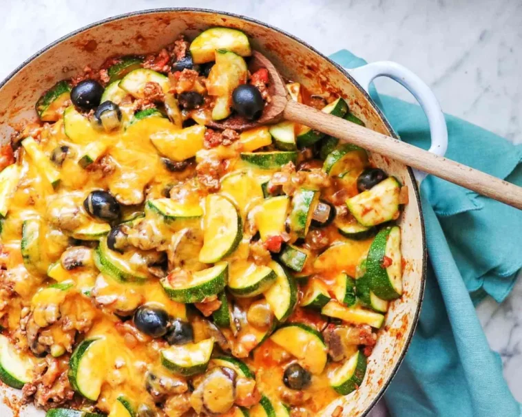 1. A skillet brimming with sautéed zucchini, black olives, and melted cheese, showcasing a vibrant and appetizing dishrecipes with ground beef in them