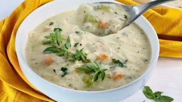 1. A warm bowl of chicken pot pie soup, featuring tender chicken, vegetables, and a creamy broth, garnished with herbs cream of chicken soup