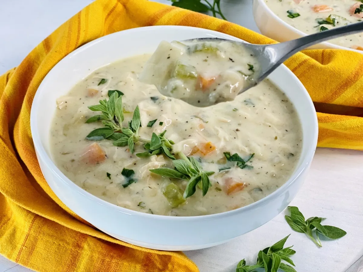 1. A warm bowl of chicken pot pie soup, featuring tender chicken, vegetables, and a creamy broth, garnished with herbs cream of chicken soup