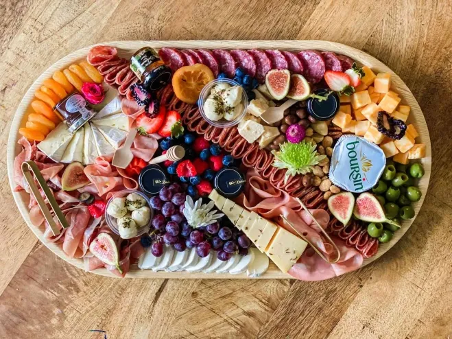 1. A beautifully arranged platter featuring an assortment of meats, cheeses, fresh fruits, and colorful vegetables luncheon ideas