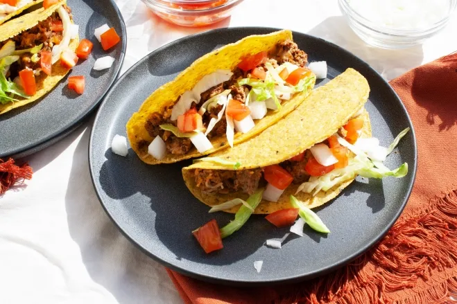 1. Two tacos on white plates accompanied by a bowl of vibrant red salsa, ready to be enjoyed food recipes with ground beef