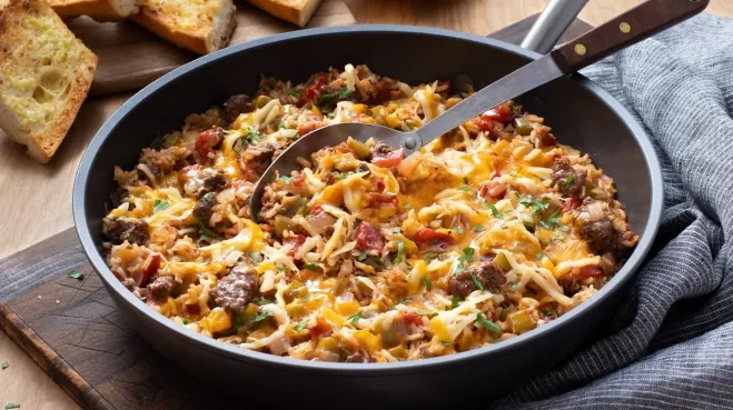 A skillet filled with a delicious chili cheese casserole, showcasing melted cheese and hearty chili ingredients ideas with ground beef for dinner