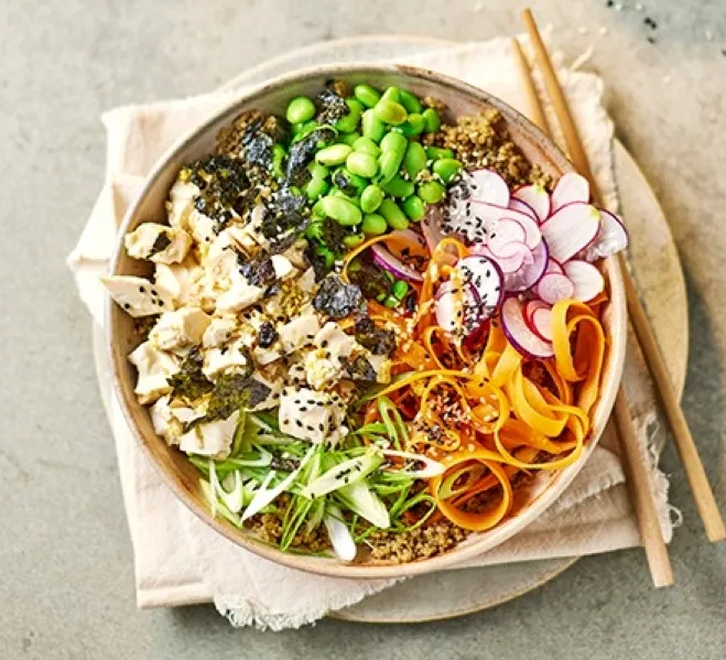 A bowl filled with colorful vegetables, rice, and tender chicken pieces, showcasing a nutritious meal ideas for healthy lunches