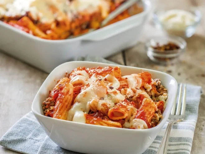 A delicious serving of baked pasta topped with savory meat and melted cheese, presented in a rustic dish recipes with groundbeef