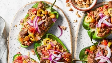 1. A plate of stuffed peppers filled with meat and vegetables, beautifully arranged and ready to be servedbeef ground meat recipes