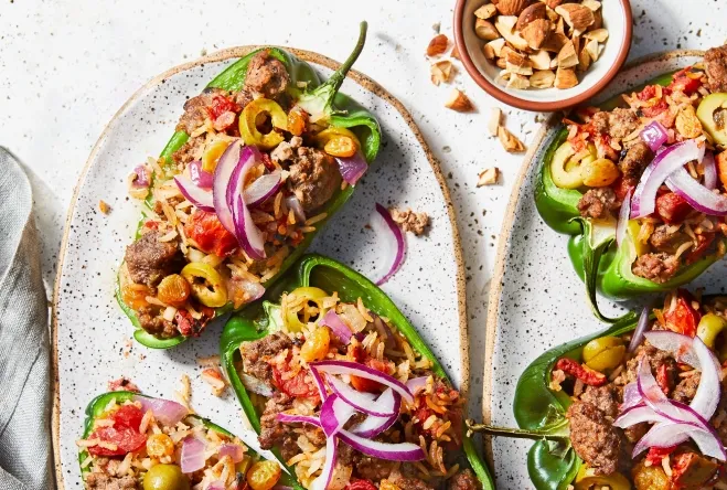 1. A plate of stuffed peppers filled with meat and vegetables, beautifully arranged and ready to be servedbeef ground meat recipes