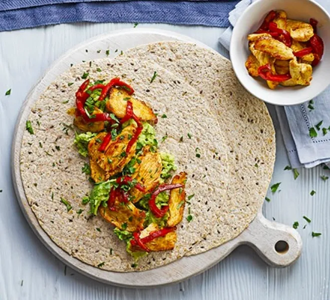 Chicken and vegetables wrapped in tortillas, elegantly presented on a plate, showcasing a colorful and appetizing meal ideas for healthy lunches