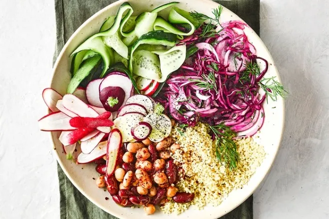 A vibrant bowl of salad featuring a mix of fresh vegetables and beans, showcasing a healthy and colorful meal ideas for healthy lunches