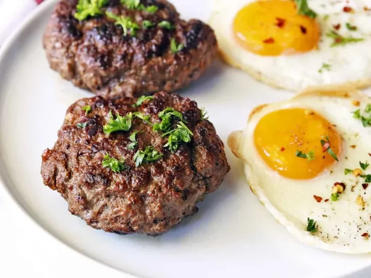 1. Two eggs on a plate accompanied by two hamburgers, creating a hearty and appetizing meal presentationground hamburger meat recipes