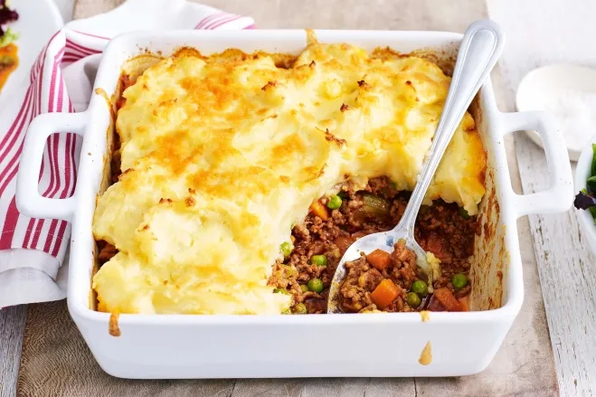 A casserole dish filled with a hearty mix of meat and colorful vegetables, ready to be served beef hamburger recipes for dinner