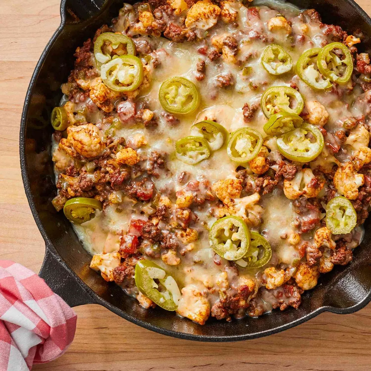 A skillet brimming with sizzling meat and melted cheese, showcasing a delicious and hearty meal dinner ideas using ground beef