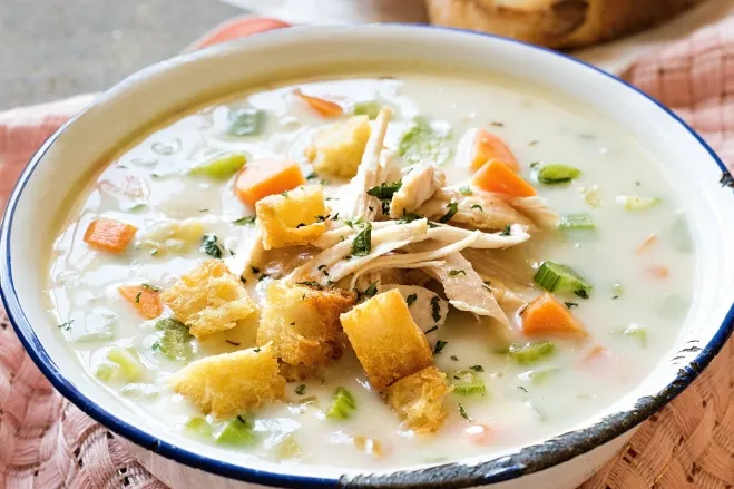 1. A warm bowl of chicken pot pie soup, featuring tender chicken, vegetables, and a creamy broth, garnished with herbs cream of chicken soup