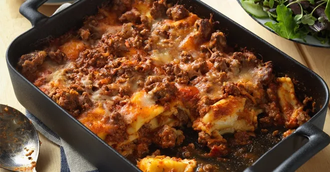  A delicious baked lasagna layered with savory meat and melted cheese, served in a rustic dish dinner ideas using ground beef