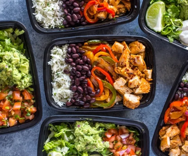  Six black plastic containers filled with chicken, rice, black beans, and assorted vegetables arranged neatly lunchtime ideas