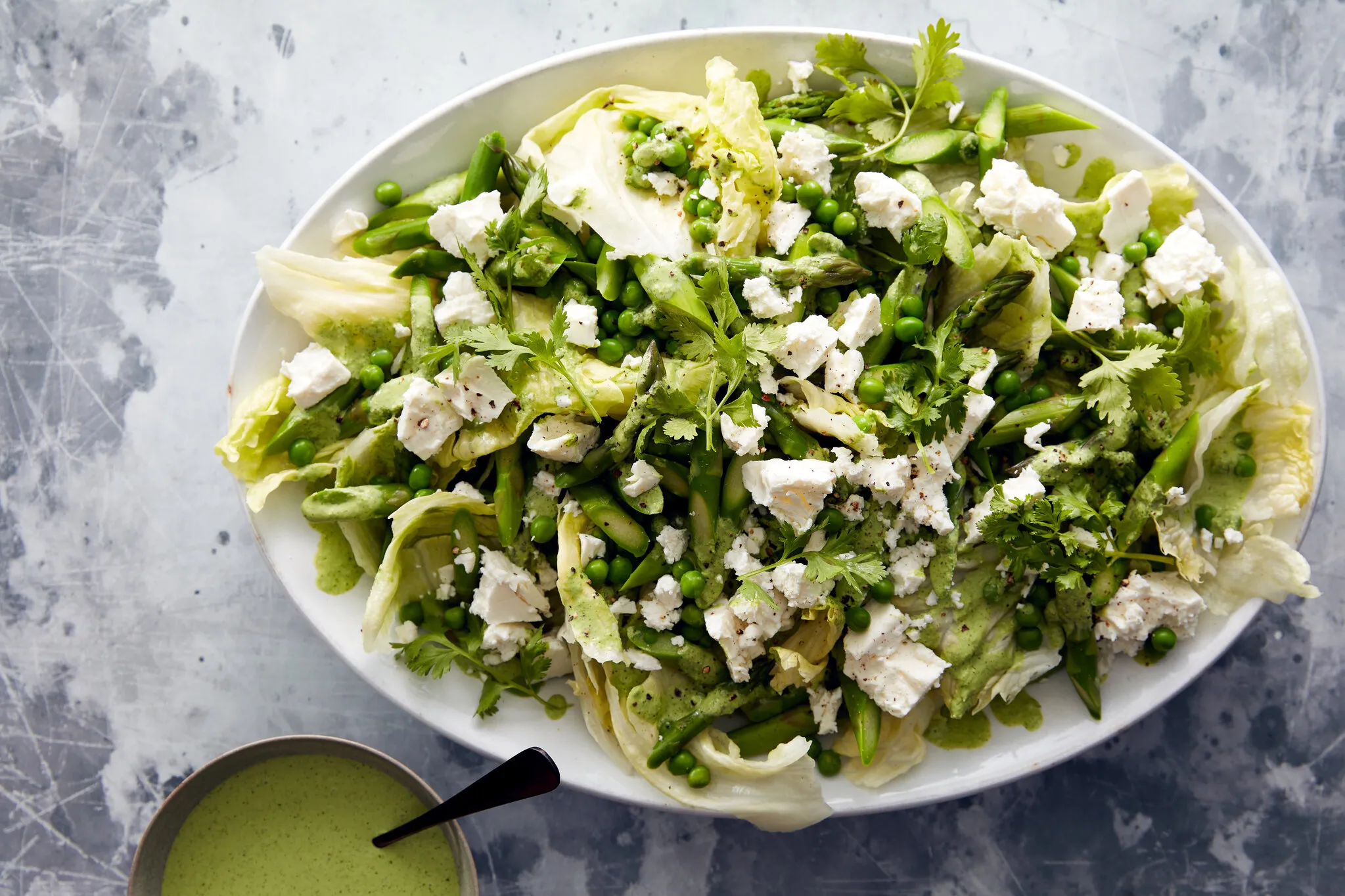 1. A vibrant salad featuring green beans, crumbled feta cheese, and a drizzle of dressing, showcasing fresh ingredients luncheon ideas