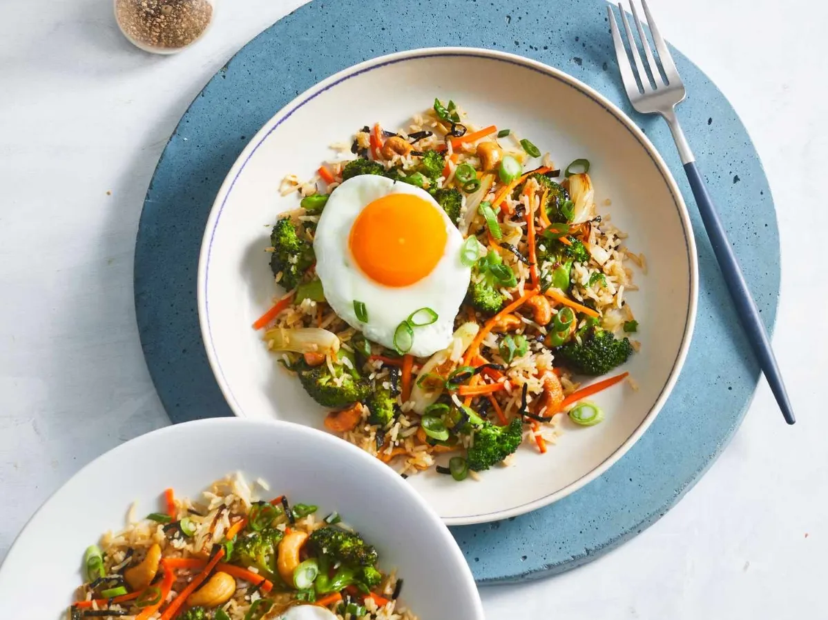 Two plates of food, each featuring a perfectly cooked egg, arranged neatly on a table ideas for healthy lunches