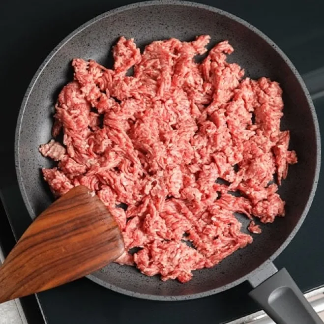 1. Ground beef sizzling in a frying pan, showcasing its rich color and texture as it cooksground beef and recipes